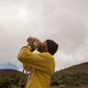 A Hawaiian who opposes construction of the Thirty Meter Telescope blows a conch shell near the summit of Mauna Kea in August, 2015. Image: Caleb Jones/AP